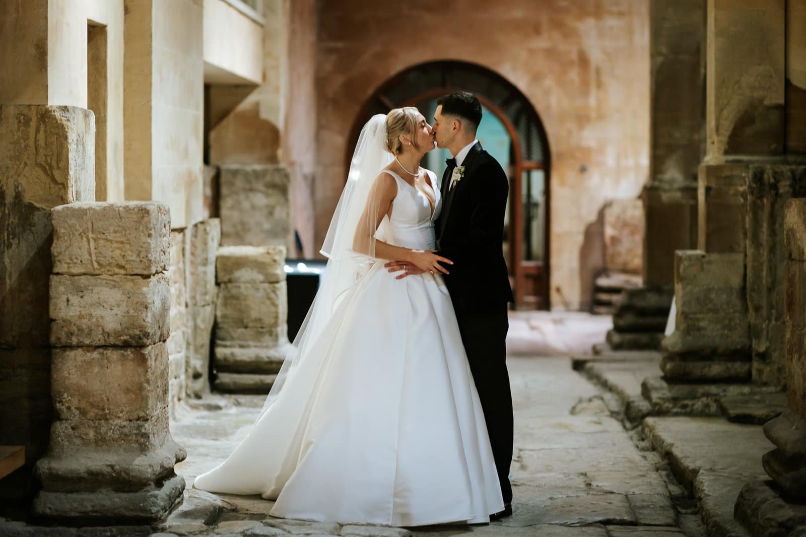 Hybrid Wedding Photographer Somerset 9 Couple kissing in a historic setting.